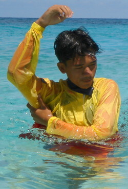 Lifeguard signals both hands up danger